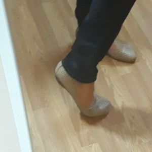 Light tan Clark's perforated flats